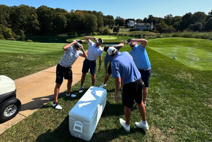 Golfers relaxing with drinks together